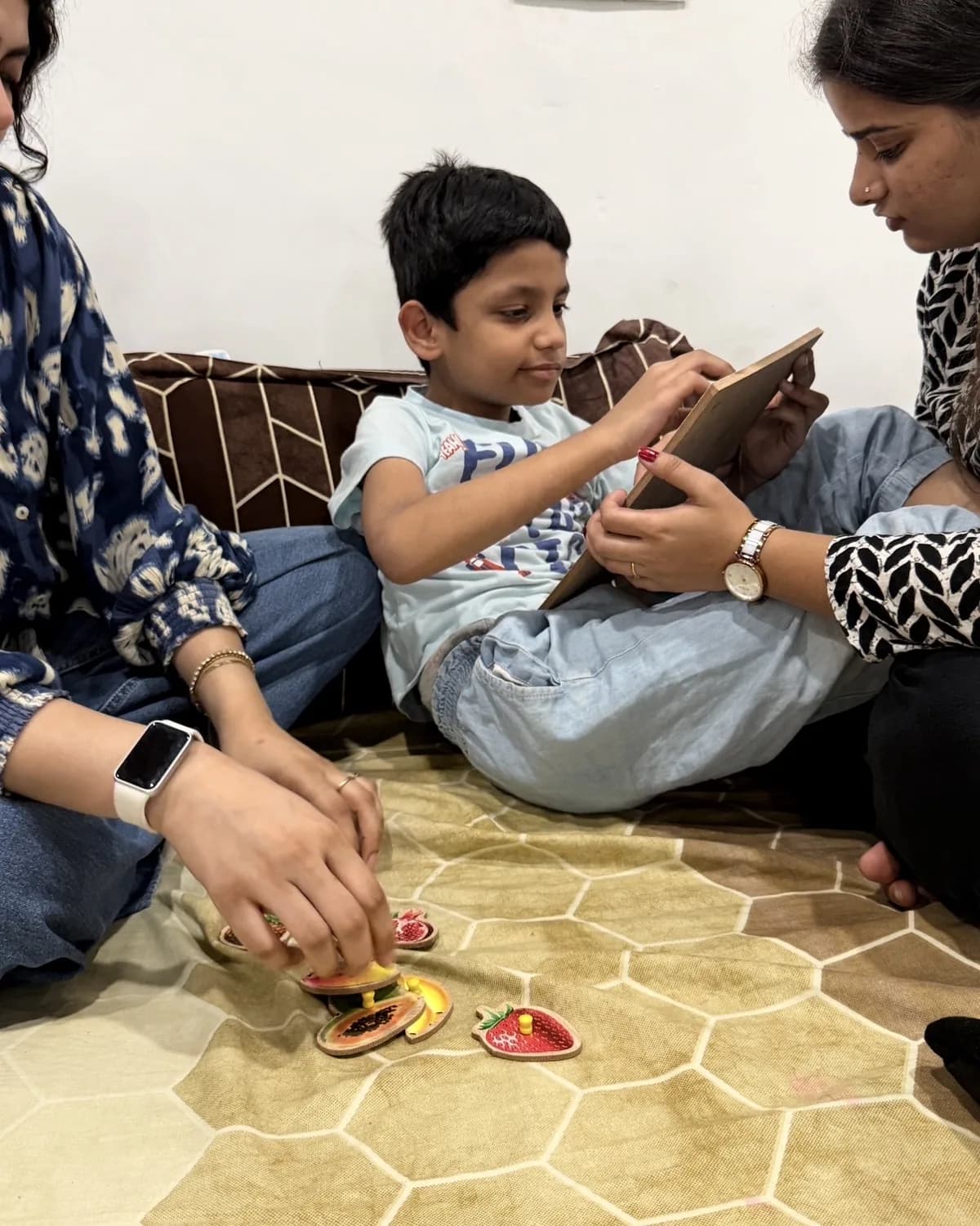 Two therapists sitting with a boy during a calm session